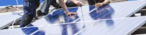 Installateure am Dach beim Bau einer Photovoltaikanlage